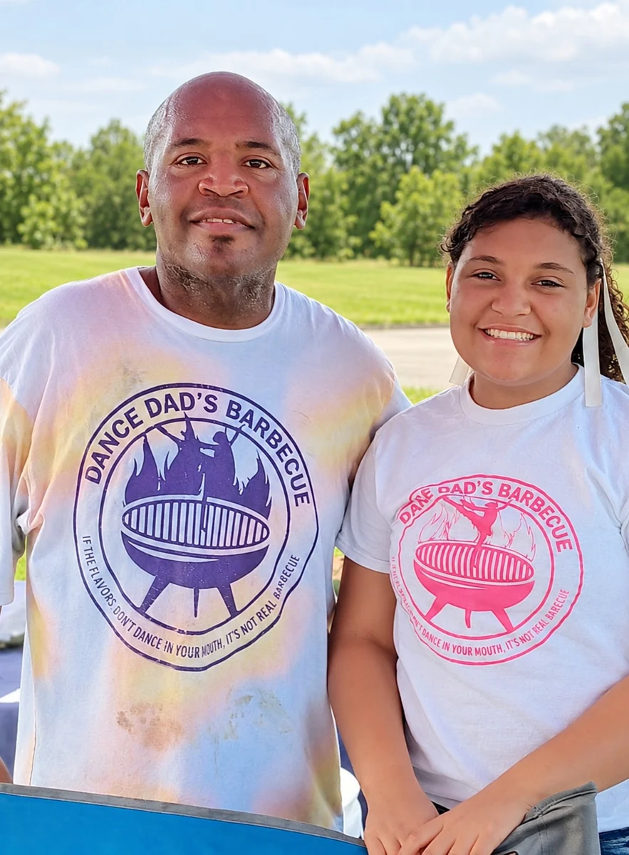 Demetrius and Eliza together in their Dance Dad’s Barbecue shirts